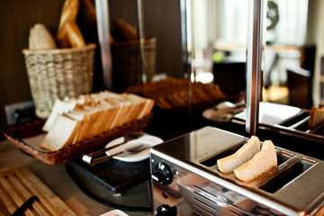 Assortment of fresh pastry on table in buffet with toaster