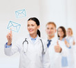 © Syda Productions - smiling female doctor pointing to envelope