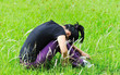 depress woman sit in grass