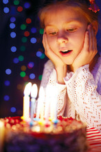 Girl Blows Out The Candles On The Cake
