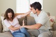 © lightwavemedia - Man consoling a sad woman in living room
