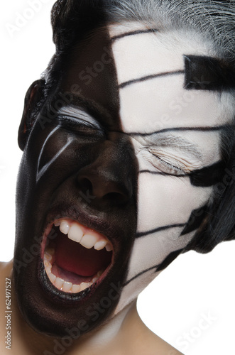 Fototapeta na wymiar Portrait of screaming woman with face art as piano