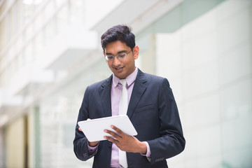 indian business male with a tablet