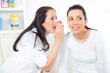 © Mediteraneo - Gossip. Two young girlfriends whispering. Telling secrets.