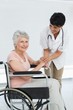 © WavebreakMediaMicro - Doctor talking to a senior patient in wheelchair