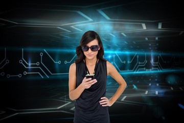 Poster - Glamorous brunette using smartphone against circuit board