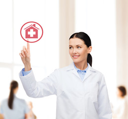 Poster - smiling female doctor pointing to hospital sign