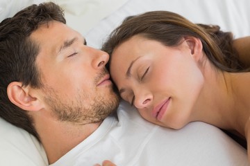 Wall Mural - Relaxed couple sleeping together in bed