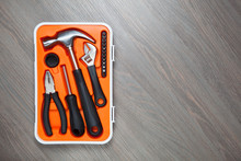 Orange Tools Box Against Wooden Background