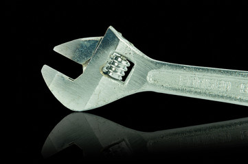 Adjustable Wrench and shadow effect on black background