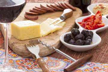 Havarti cheese and savory snacks with red wine