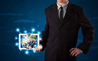 Businessman presenting 3d earth globe in tablet