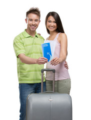 Wall Mural - Portrait of embracing couple with suitcase and tickets