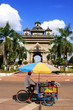 Street food seller on a bicycle in front of Victory Gate Patuxai