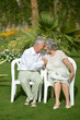 © aletia2011 - Senior couple sitting at tropic garden