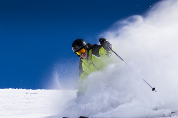 Wall Mural - alpine skier on piste, skiing downhill