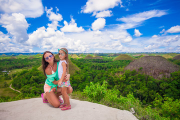 Young mother and her adorable little girl on a background of the