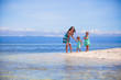 © travnikovstudio - Adorable little girls and young mother have fun on tropical