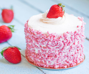 Wall Mural - Strawberry cake with white cream on wooden background