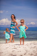 © travnikovstudio - Young mother and two her daughters have fun at exotic beach on