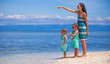 © travnikovstudio - Young mother and two her daughters at exotic beach on sunny day