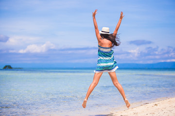 Poster - Young beautiful woman jumping in the beach