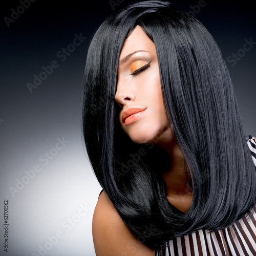 Fototapeta na wymiar Beautiful brunette woman with long black straight hair