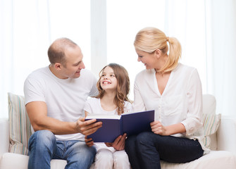 Canvas Print - smiling parents and little girl with at home