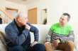 © DariaTrofimova - men sitting on sofa at home and talking
