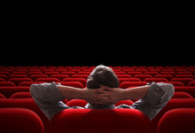 One Man Sitting In Empty Cinema Or Theater Auditorium