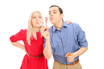 Poster - Young couple having fun, blowing bubbles