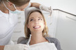 © Westend61 - Germany, Young woman getting her teeth examined by dentist