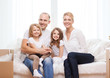 © Syda Productions - smiling parents and two little girls at new home