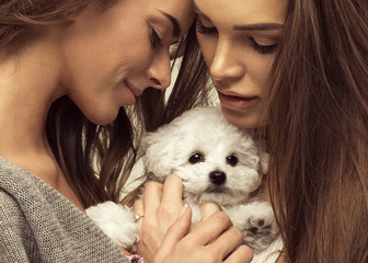 Wall Mural - Portrait of young women with cute puppy