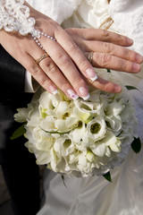 Wall Mural - Wedding bouquet and hands with rings.