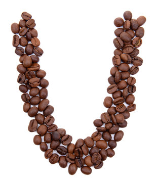 Alphabet from coffee beans isolated on white