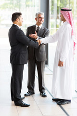 Wall Mural - translator introducing muslim businessman to business partner