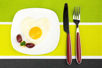 Scrambled eggs with bread on plate, on color napkin