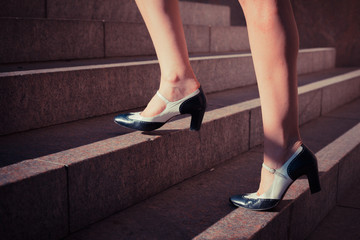 Young woman walking up stairs