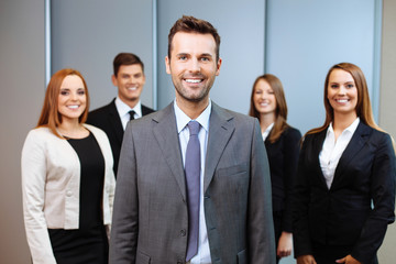 Wall Mural - Group of business people with team leader in foreground