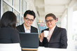 © wong yu liang - Group of  asian business people gathered together at a table dis