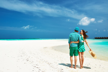 Couple in green on a beach at Maldives