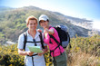 © goodluz - Hikers in country path looking at map