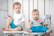 © golovianko - Two brothers sitting on chairs in vintage interior