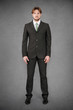 © pio3 - Young businessman full body front portrait against grunge backgr