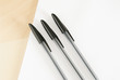 © Mint Images - Three ball point pens lined up in a row on a white background.