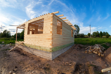 Canvas Print - New residential construction home framing against a blue sky