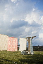 A Washing Line With Household Linens And Washing Hung Out To Dry In The Fresh Air. 