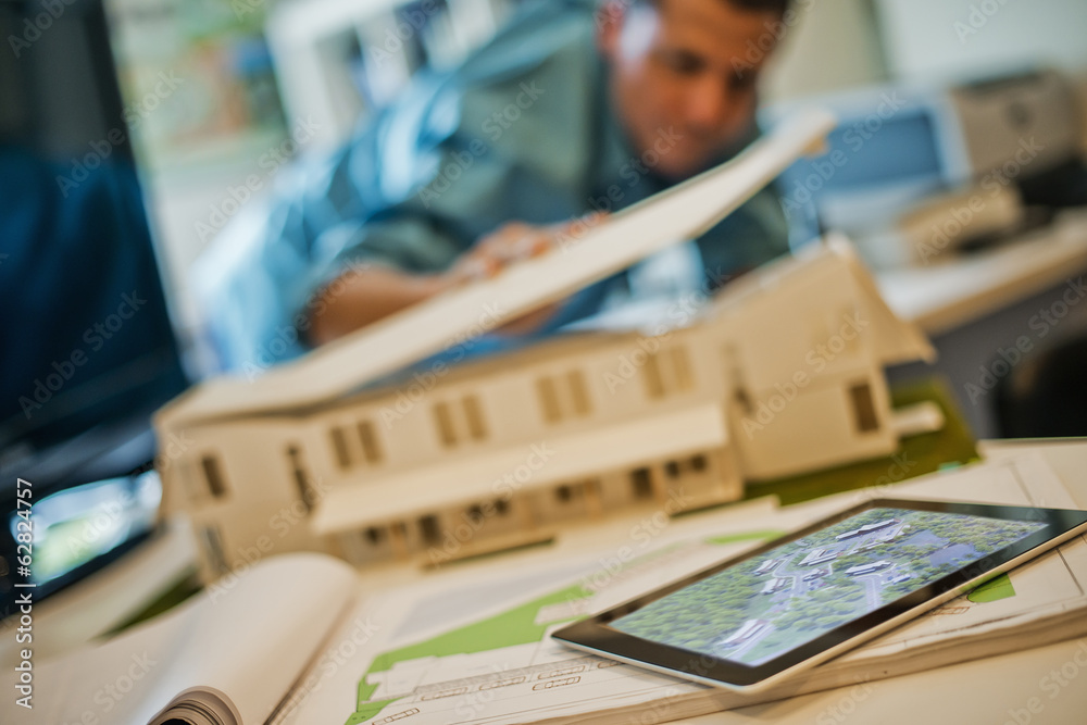 Architects working on a green construction project, using computer ...