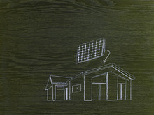 A Line Drawing Image On Grained Wood. A Green Building Project, A House With Solar Panels For The Roof.